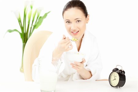 simsearch:400-08977333,k - Happy woman in bathrobe  for breakfast over white Stock Photo - Budget Royalty-Free & Subscription, Code: 400-04271520