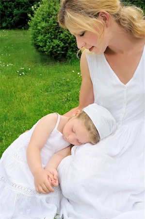 sleeping backyard - Young mother and daughter resting in meadow Stock Photo - Budget Royalty-Free & Subscription, Code: 400-04273267