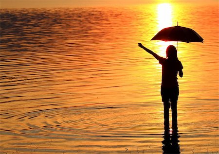 silhouette girl with umbrella - silhouette of young woman against summer sunset Stock Photo - Budget Royalty-Free & Subscription, Code: 400-04284122