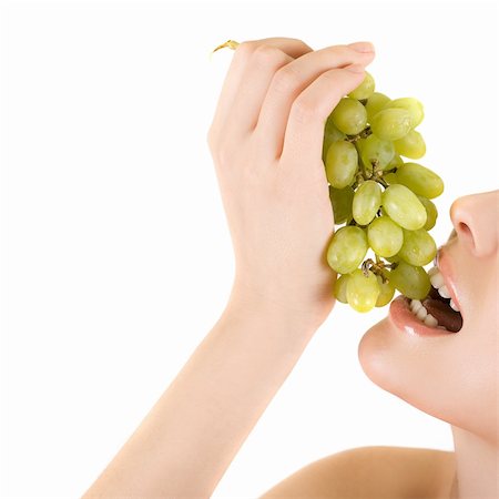 simsearch:400-04564052,k - Closeup of woman mouth with green grape on a white Foto de stock - Super Valor sin royalties y Suscripción, Código: 400-04284676