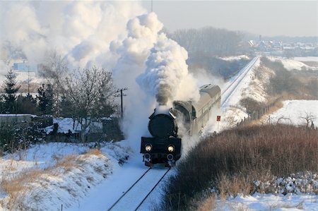 Vintage steam train passing through snowy countryside Stock Photo - Budget Royalty-Free & Subscription, Code: 400-04284785