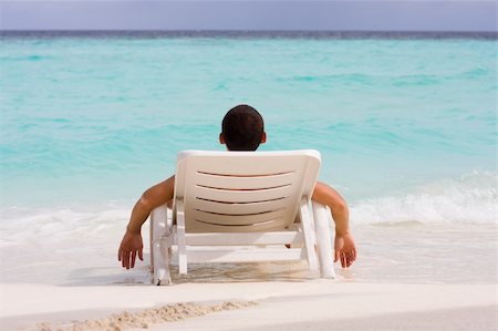 Men relaxing at a tropical beach Foto de stock - Super Valor sin royalties y Suscripción, Código: 400-04284836
