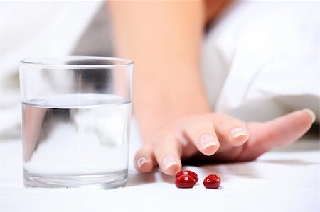 simsearch:400-05251905,k - A close up of a female hand reaching for some tablets over white background Stock Photo - Budget Royalty-Free & Subscription, Code: 400-04284872