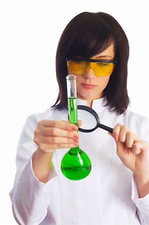simsearch:400-04522609,k - Female scientist looking at tube through magnifying lens Stock Photo - Budget Royalty-Free & Subscription, Code: 400-04285853