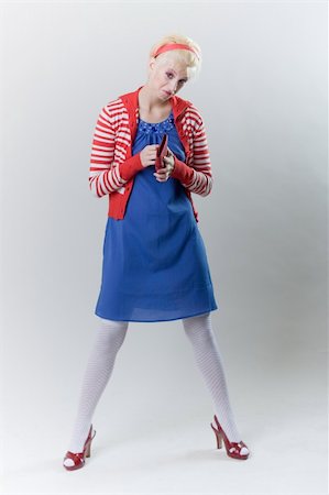 emotion pose blond girl in red woolly Stockbilder - Microstock & Abonnement, Bildnummer: 400-04286289