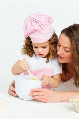 simsearch:400-05749768,k - Cute girl  preparing a cake with her mother in the kitchen Stock Photo - Budget Royalty-Free & Subscription, Code: 400-04286995