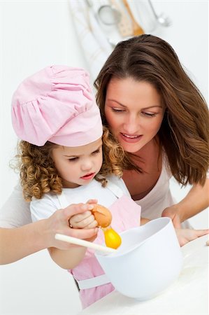 Mother and daughter breaking eggs while cooking together in the kitchen Stock Photo - Budget Royalty-Free & Subscription, Code: 400-04286998