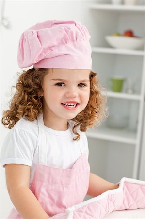 Portrait of a cute girl wearing hat and gloves in the kitchen Stock Photo - Budget Royalty-Free & Subscription, Code: 400-04286991
