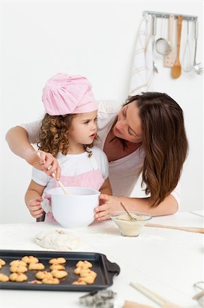 rolling over - Attentive mother learning her daughter how to cook Stock Photo - Budget Royalty-Free & Subscription, Code: 400-04287000