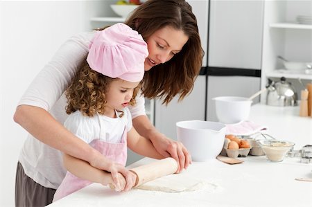 Mother and daughter using a rolling pin together in the kitchen Stock Photo - Budget Royalty-Free & Subscription, Code: 400-04287001