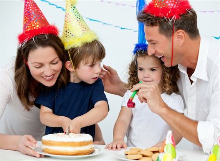 simsearch:400-04311221,k - Happy family blowing candles together for a birthday at home Photographie de stock - Aubaine LD & Abonnement, Code: 400-04287040