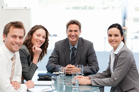 simsearch:400-04287075,k - Portrait of a positive manager with his team sitting at a table Fotografie stock - Microstock e Abbonamento, Codice: 400-04287069