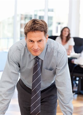 simsearch:400-05742796,k - Confident man posing in front of his colleague during a meeting at the office Stock Photo - Budget Royalty-Free & Subscription, Code: 400-04287205