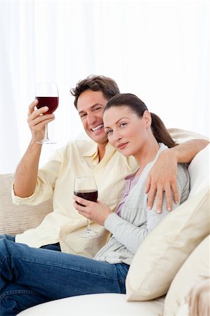 simsearch:400-04663577,k - Happy couple enjoying their glasses of red wine on the sofa at home Stock Photo - Budget Royalty-Free & Subscription, Code: 400-04287261