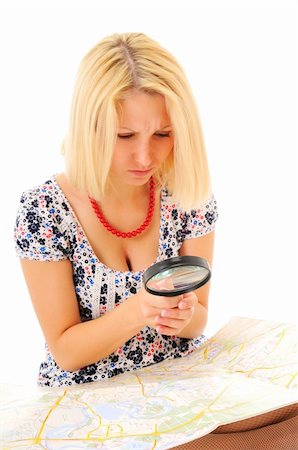 Attractive young blonde studying map over white background Stock Photo - Budget Royalty-Free & Subscription, Code: 400-04288384