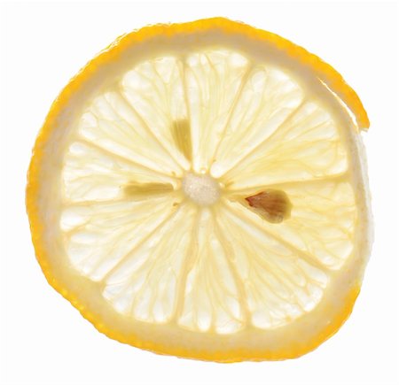 simsearch:400-05057164,k - A backlit slice of lemon isolated on white background Fotografie stock - Microstock e Abbonamento, Codice: 400-04288711