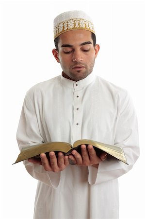 Man wearing cultural clothing is reading or studying a religious holy book.  White background. Photographie de stock - Aubaine LD & Abonnement, Code: 400-04288724