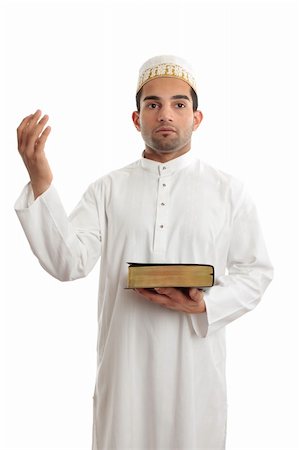 A man holding a holy book such as a bible or qur'an and hand raised in worship.  White background. Photographie de stock - Aubaine LD & Abonnement, Code: 400-04289058