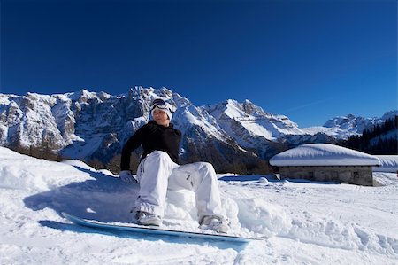 extreme cold clothes women - Happy girl with snowboard resting on snow Stock Photo - Budget Royalty-Free & Subscription, Code: 400-04289182