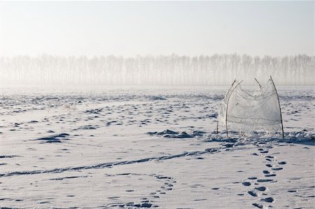 russia frozen lake - Ice-hole in the center of a frozen lake Stock Photo - Budget Royalty-Free & Subscription, Code: 400-04289326