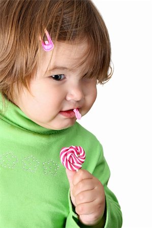 simsearch:400-07568470,k - Toddler girl with chubby cheeks eating a sticky lollipop Stockbilder - Microstock & Abonnement, Bildnummer: 400-04281318