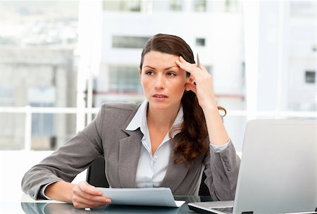simsearch:400-04008684,k - Serious female executive finding ideas while working at her desk with laptop Stockbilder - Microstock & Abonnement, Bildnummer: 400-04281575