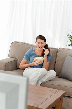 simsearch:400-04268918,k - Woman laughing while watching a movie on television in the living room at home Stockbilder - Microstock & Abonnement, Bildnummer: 400-04281611