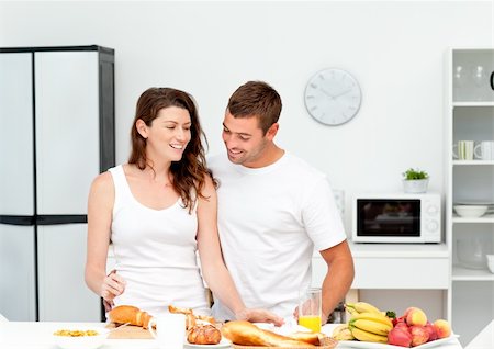 Lovely couple preparing their breakfast together in the kitchen Stock Photo - Budget Royalty-Free & Subscription, Code: 400-04281613