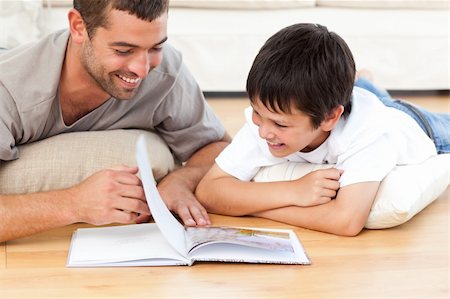 simsearch:400-05751566,k - Cute boy reading a book with his father on the floor at home Stock Photo - Budget Royalty-Free & Subscription, Code: 400-04281657