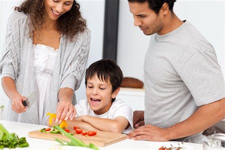 simsearch:400-04792006,k - Happy family preparing a salad together in the kitchen at home Stock Photo - Budget Royalty-Free & Subscription, Code: 400-04281658