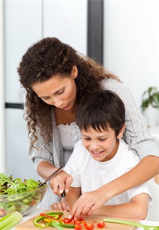 simsearch:400-04792006,k - Attentive mother helping her son to cut vegetables in the kitchen Stock Photo - Budget Royalty-Free & Subscription, Code: 400-04281660