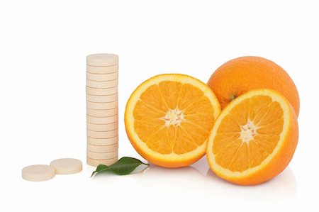 simsearch:400-08618279,k - Vitamin c tablet stack with orange fruit whole and in half with leaf sprig, over white background. Photographie de stock - Aubaine LD & Abonnement, Code: 400-04281743
