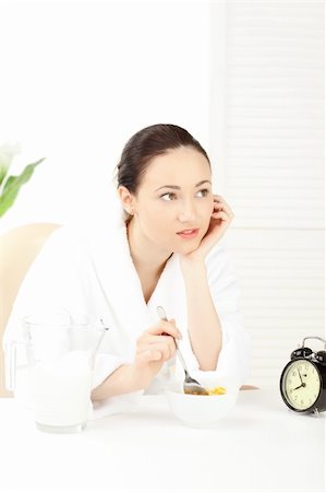 simsearch:400-08977333,k - Happy woman in bathrobe  for breakfast over white Stock Photo - Budget Royalty-Free & Subscription, Code: 400-04282735