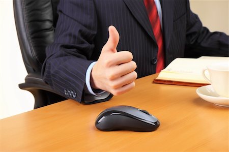simsearch:400-04782141,k - Businessman at his workplace hold thumbs up. Stock Photo - Budget Royalty-Free & Subscription, Code: 400-04283681