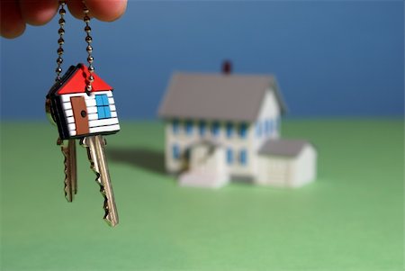 simsearch:625-02265924,k - A hand holds a keychain with a home key infront of a house. Foto de stock - Super Valor sin royalties y Suscripción, Código: 400-04294185