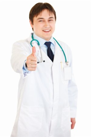 Smiling medical doctor showing thumbs up gesture  isolated on white Stock Photo - Budget Royalty-Free & Subscription, Code: 400-04294401