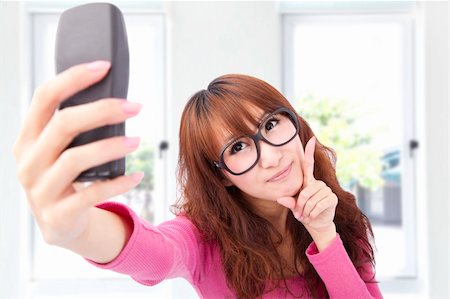 Young asian woman take photo by her cell phone Stock Photo - Budget Royalty-Free & Subscription, Code: 400-04294832