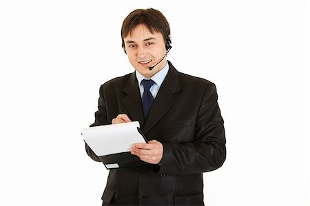 Smiling modern businessman with headset making notes in document isolated on white Stock Photo - Budget Royalty-Free & Subscription, Code: 400-04295159