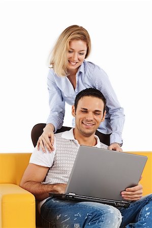 Happy young man and woman sitting together and looking at computer screen Photographie de stock - Aubaine LD & Abonnement, Code: 400-04295699