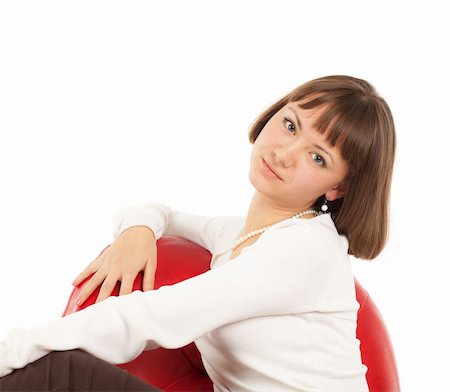 Pretty young blond woman sitting in red leather chair Stock Photo - Budget Royalty-Free & Subscription, Code: 400-04295703