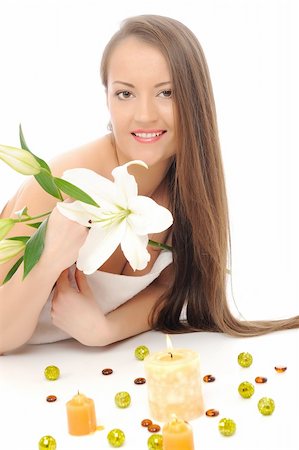 simsearch:400-04881818,k - Beautiful woman with pure healthy skin and long hair with a flower in spa salon relaxing. isolated on white background Fotografie stock - Microstock e Abbonamento, Codice: 400-04295917