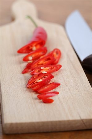 simsearch:600-05973313,k - Sliced red chili pepper on a cutting board. Shallow dof Photographie de stock - Aubaine LD & Abonnement, Code: 400-04296315