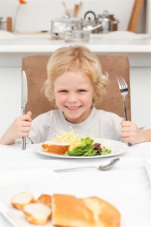 Portrait of a little boy ready to eat pasta and salad in the kitchen Stock Photo - Budget Royalty-Free & Subscription, Code: 400-04296567