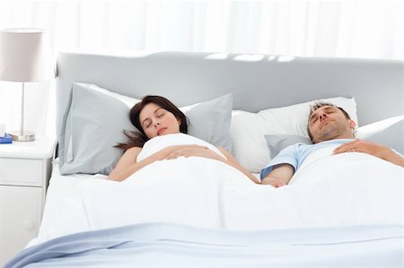 Lovely couple holding their hands while sleeping on their bed at home Stock Photo - Budget Royalty-Free & Subscription, Code: 400-04296650