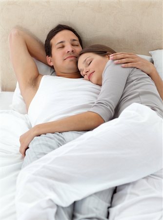 sleeping bed full body - Cute couple sleeping in each other's arms on their bed at home Stock Photo - Budget Royalty-Free & Subscription, Code: 400-04296698