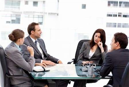 Thoughtful businesswoman talking to her team during a meeting at work Stock Photo - Budget Royalty-Free & Subscription, Code: 400-04296691