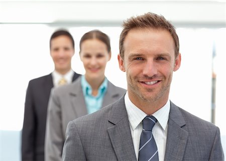Three happy partners posing in a row in the office Stock Photo - Budget Royalty-Free & Subscription, Code: 400-04296710