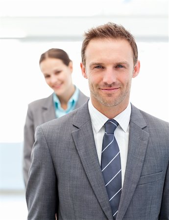 simsearch:6109-06002735,k - Two smiling business people posing in a row at work Stock Photo - Budget Royalty-Free & Subscription, Code: 400-04296712