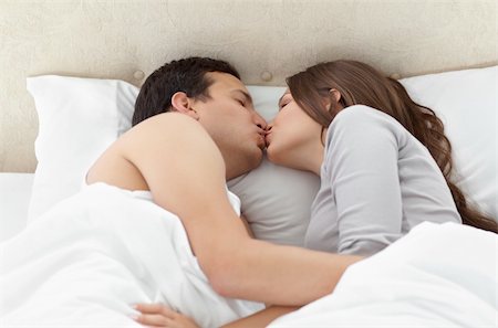 sleeping bed full body - Lovely couple kissing in each other's arms on the bed at home Stock Photo - Budget Royalty-Free & Subscription, Code: 400-04296735