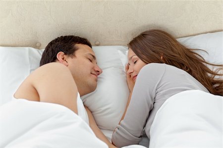 sleeping bed full body - Serene couple sleeping together on their bed at home Stock Photo - Budget Royalty-Free & Subscription, Code: 400-04296732